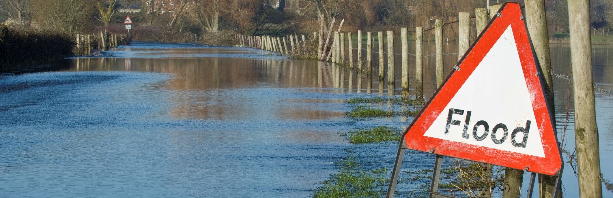 Flooded road and fields A sewage treatment plant under water in a flooded area of a garden