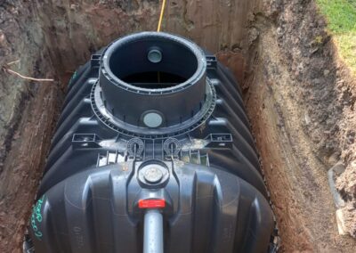A sewage treatment plant in a freshly dug hole ready for installation