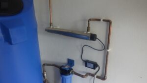 An old ultra violet filtration system mounted on a wall