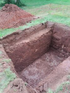 A freshly dug hole ready to site a sewage treatment plant in a customer's garden