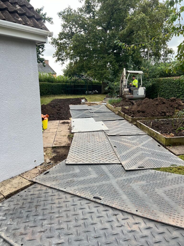Heavy duty protection matting laid on a garden to protect the lawn and flower beds
