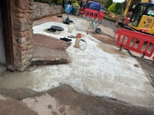Concreting a driveway during the installation of a sewage treatment plant underneath