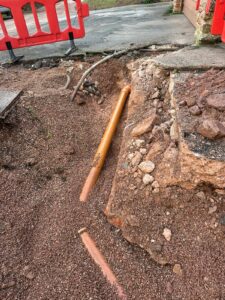 A photo showing the pipe connections being fitted to a sewage treatment plant during installation