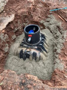 A Graf sewage treatment plant being set in concrete in the ground during installation